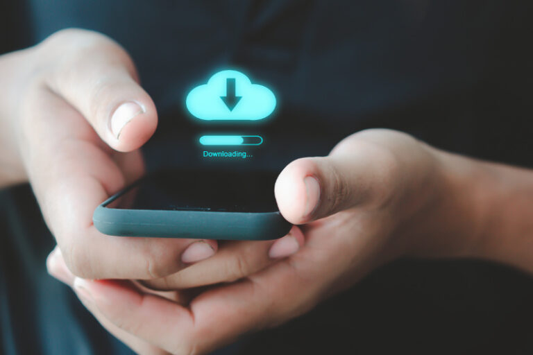 Someone holding a smartphone with a picture of a download button above it